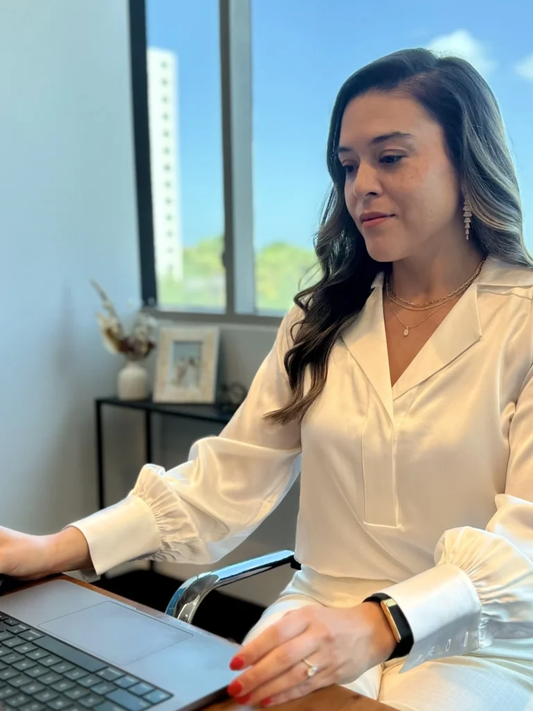 Nikki Savage of Wild Iris Financial working on a laptop in a professional office