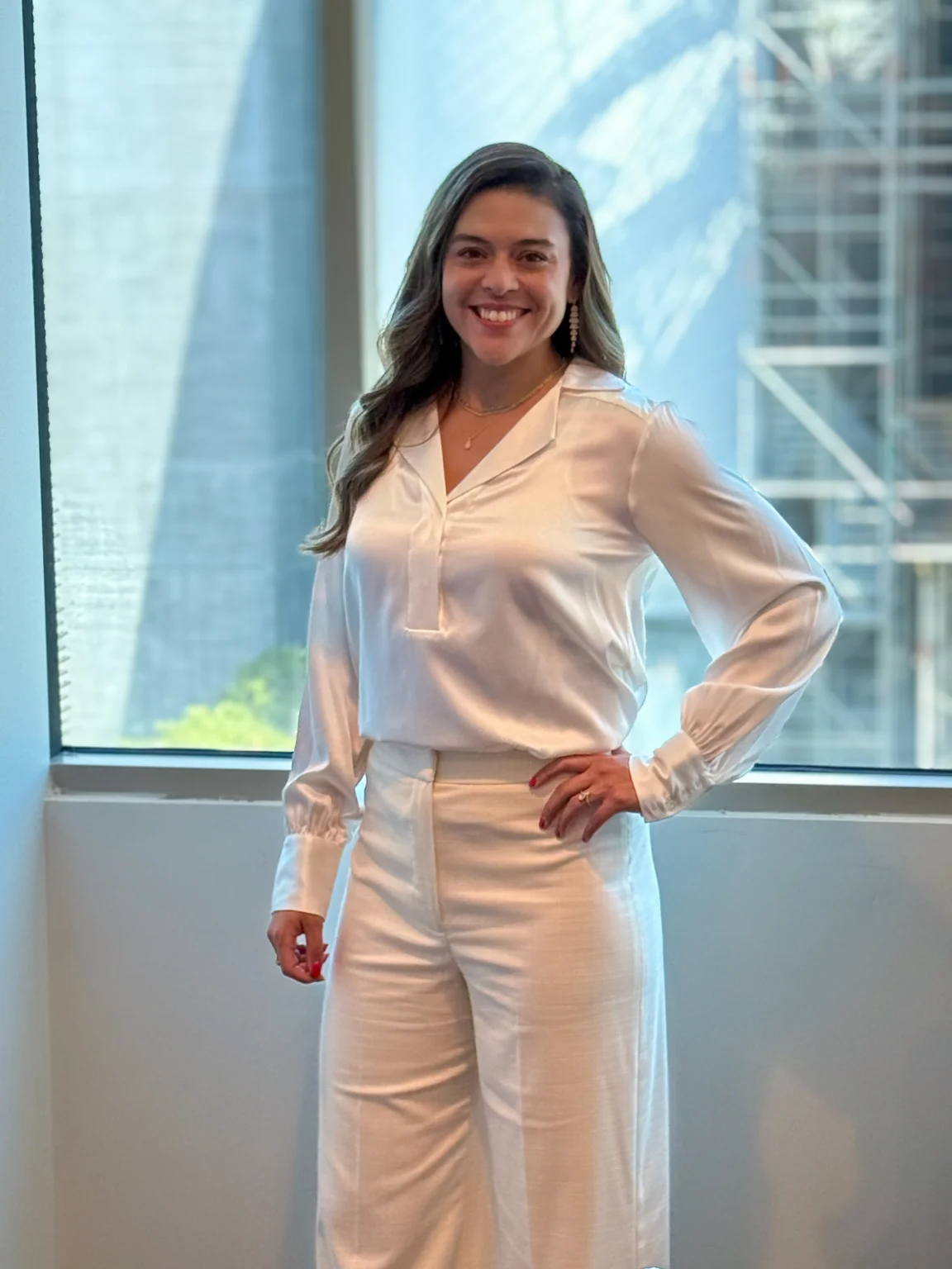 Nikki Savage, financial advisor at Wild Iris Financial, smiling in a professional office setting