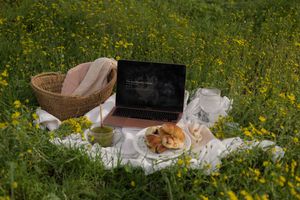 Laptop and financial documents used to review retirement savings and cash flow